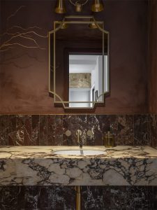 Luxury boutique powder room with marble vanity