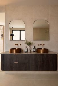 Luxury bathroom featuring Silver River Cello marble with brass vanities and tapware by ABI
