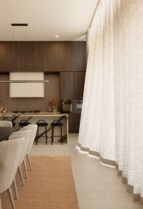 Kitchen and living area featuring ceiling to floor linen sheer curtains